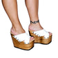 Handmade white leather wedge mule sandals with round flat old-gold studs and 15 cm natural lacquered wooden wedge by Sol Caleyo.