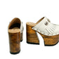 Side view of White Indian Clogs XL featuring extreme 17cm natural wood platform, white leather fringes, and antique silver metal conchos.