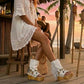 White handmade suede boho flip flop boots with fringe, carved bone, coins and 10 cm wooden heel by Sol Caleyo.