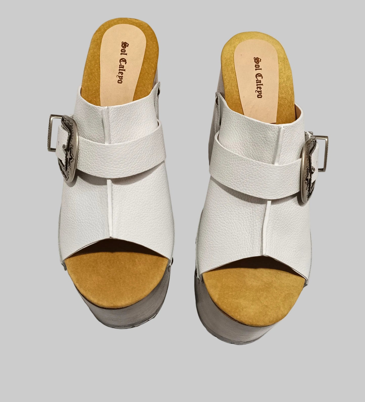 Individually handcrafted White Western Sandals showing the 17cm hand-carved wooden platform and ornate silver buckle on a white background.