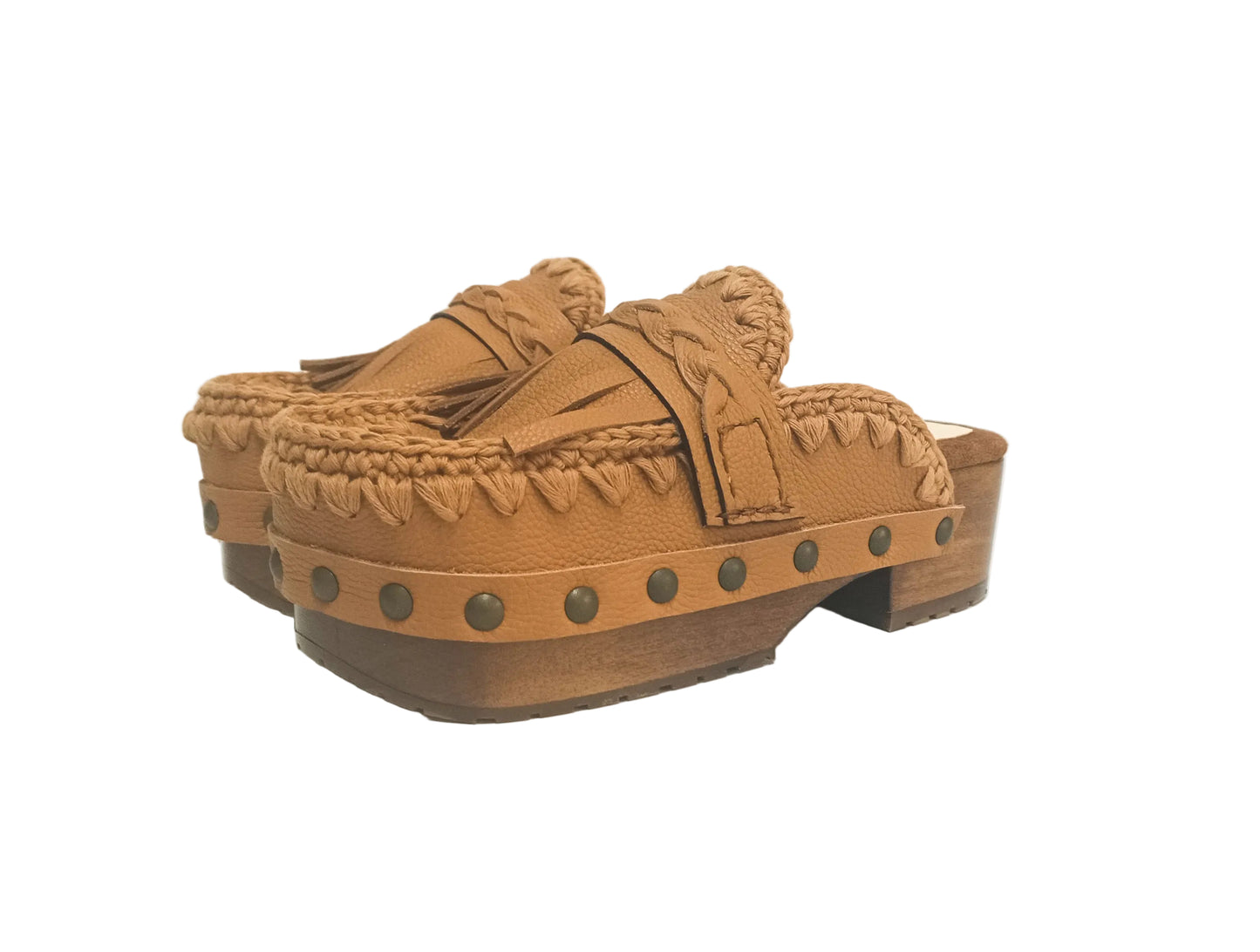 Side profile of Sol Caleyo Niza Clogs in light brown leather, showcasing hand-braided strap, crochet trim, bronze studs, and a sturdy wooden platform sole.