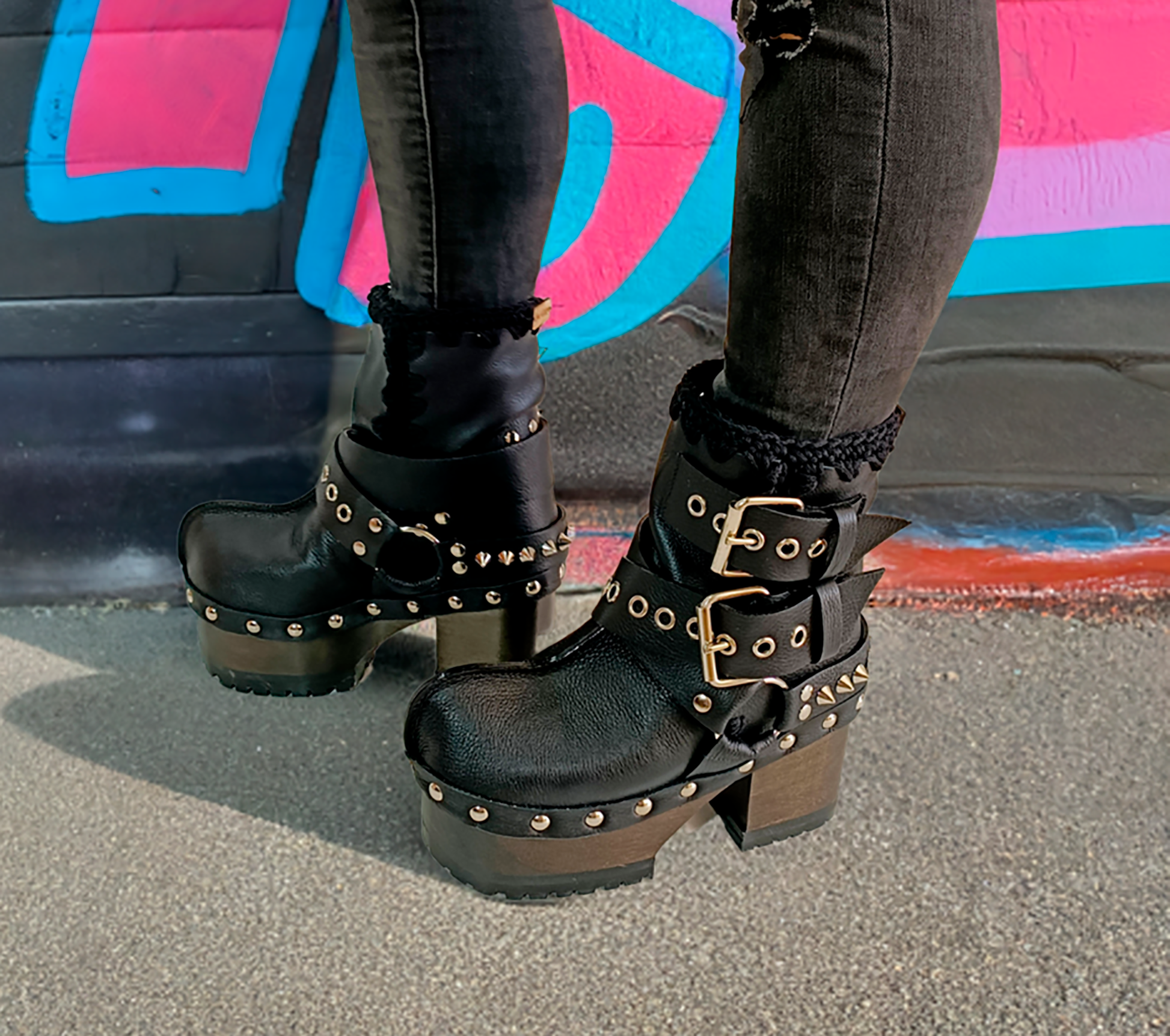 Black leather platform boots with silver studs. Black leather biker style boots with buckles. Black leather ankle boots with vintage style buckles. Leather boots with wooden heel. High-end handmade footwear by Sol Caleyo.