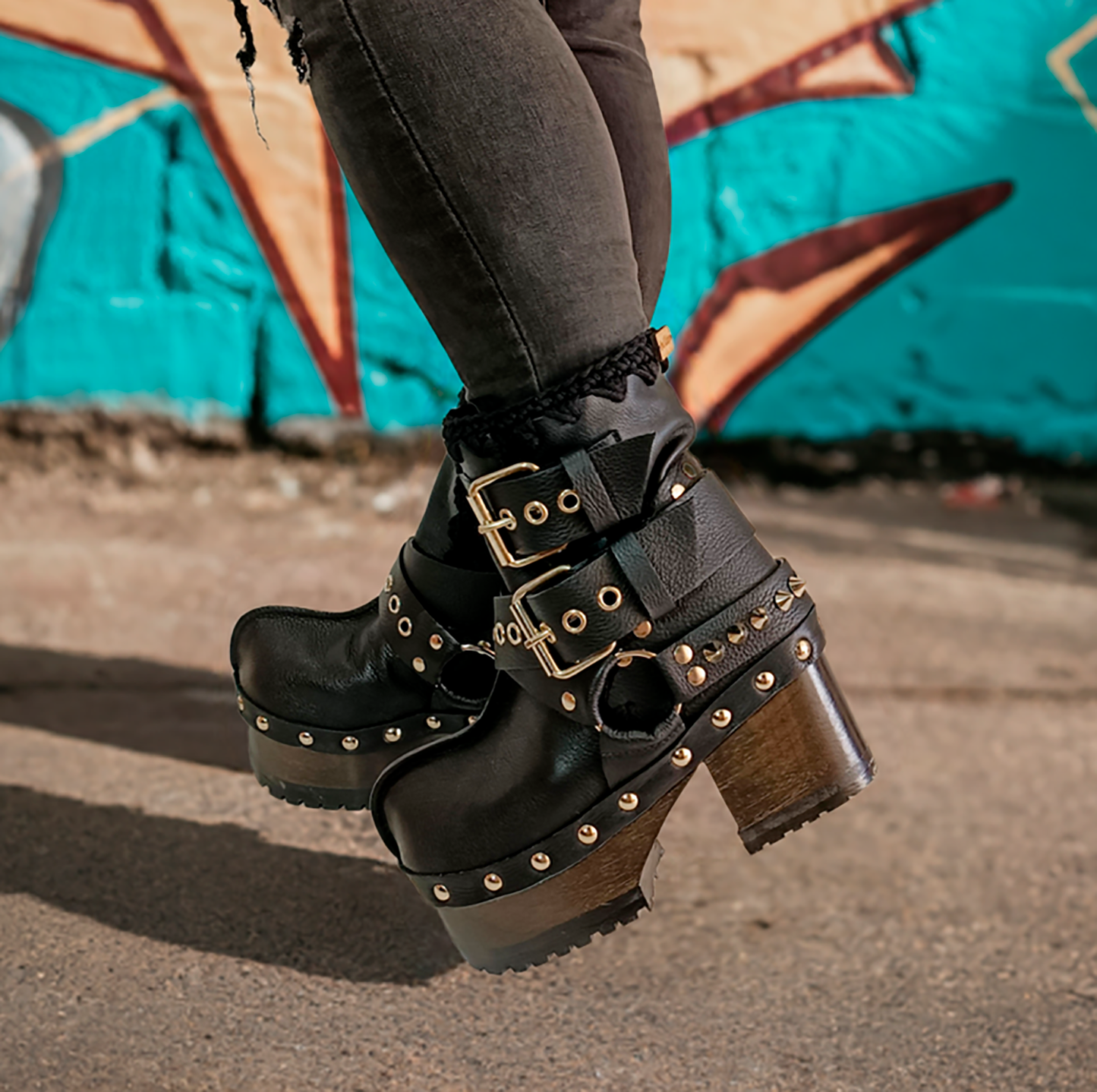 Black leather platform boots with silver studs. Black leather biker style boots with buckles. Black leather ankle boots with vintage style buckles. Leather boots with wooden heel. High-end handmade footwear by Sol Caleyo.