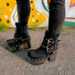 Black leather platform boots with silver studs. Black leather biker style boots with buckles. Black leather ankle boots with vintage style buckles. Leather boots with wooden heel. High-end handmade footwear by Sol Caleyo.