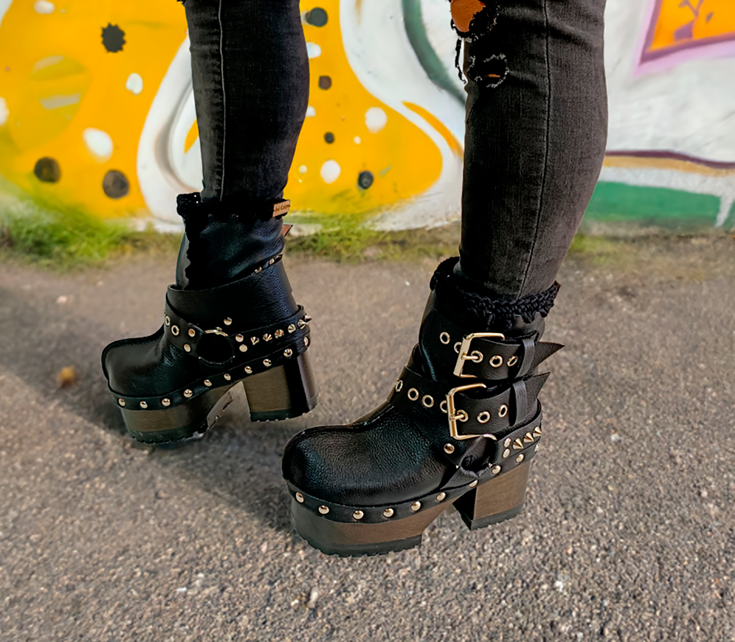 Black leather platform boots with silver studs. Black leather biker style boots with buckles. Black leather ankle boots with vintage style buckles. Leather boots with wooden heel. High-end handmade footwear by Sol Caleyo.