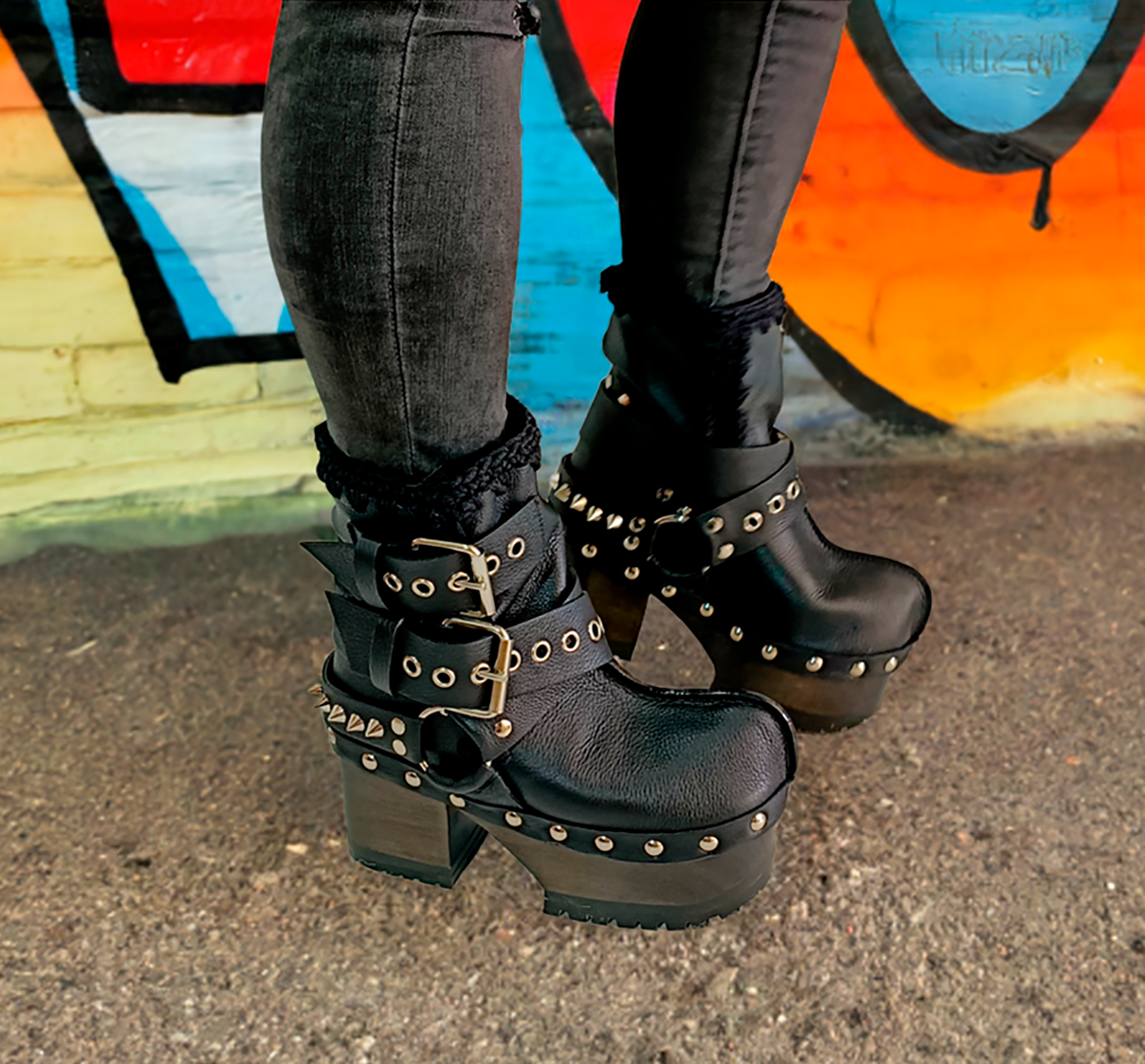 Black leather platform boots with silver studs. Black leather biker style boots with buckles. Black leather ankle boots with vintage style buckles. Leather boots with wooden heel. High-end handmade footwear by Sol Caleyo.