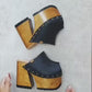 Black leather clogs in a vintage 70s style. Super high vintage-style wooden heel. Sizes 33 to 47. High-end footwear handmade by Sol Caleyo.