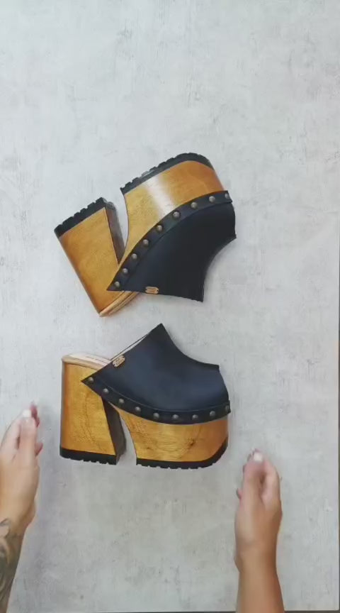 Black leather clogs in a vintage 70s style. Super high vintage-style wooden heel. Sizes 33 to 47. High-end footwear handmade by Sol Caleyo.