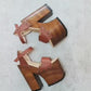 Handcrafted brown leather clogs sandals with wooden soles, high platforms, and heels
