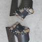 Indian Snake Clogs by Sol Caleyo: extreme 18cm straight heel wooden platforms with snake-print leather, black fringe, and Native American style metal conchos.