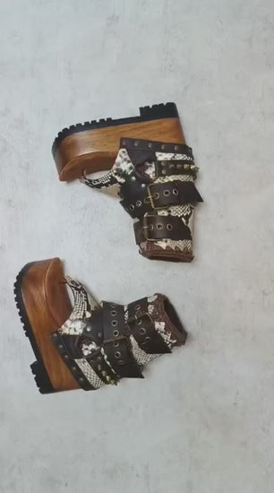 Sol Caleyo Kenya Flip Flop Snake Boots: handmade python print leather platform sandals with brown buckled straps and wooden tractor sole.