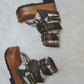 Sol Caleyo Kenya Flip Flop Snake Boots: handmade python print leather platform sandals with brown buckled straps and wooden tractor sole.