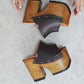 Video of the handmade Dubai dark brown leather platform mule sandals with antique-gold studs and a 13 cm natural wooden heel, by Sol Caleyo
