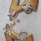 Side view of Crazy Snake Sandals by Sol Caleyo, featuring a 17 cm wooden heel, python print leather, and gold stud details on a white background.