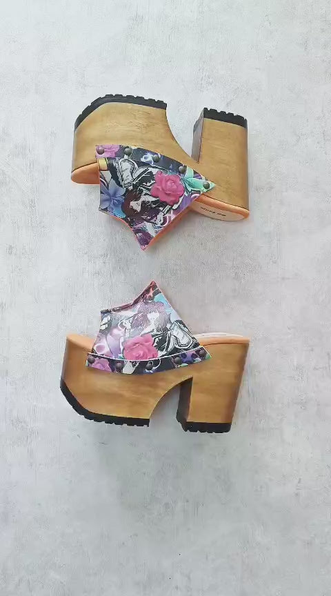 Video of the handmade Las Vegas pop print leather platform mule sandals with a wide strap, old-gold studs and a 13 cm natural wooden heel, by Sol Caleyo