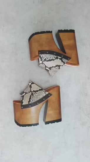 Handcrafted Snake Luxury Queen Sandals by Sol Caleyo featuring exotic snake-print leather, 17cm bell heel, and 11cm hand-carved wooden platform on a white background.
