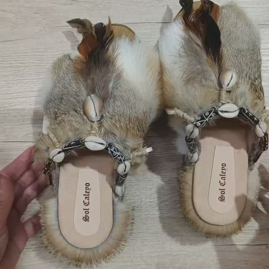 Platform clogs made of leather and rabbit fur, decorated with horns, shells and feathers for a bohemian style. Sizes 34 to 47. The Viking Clogs are an exclusive design by Sol Caleyo.