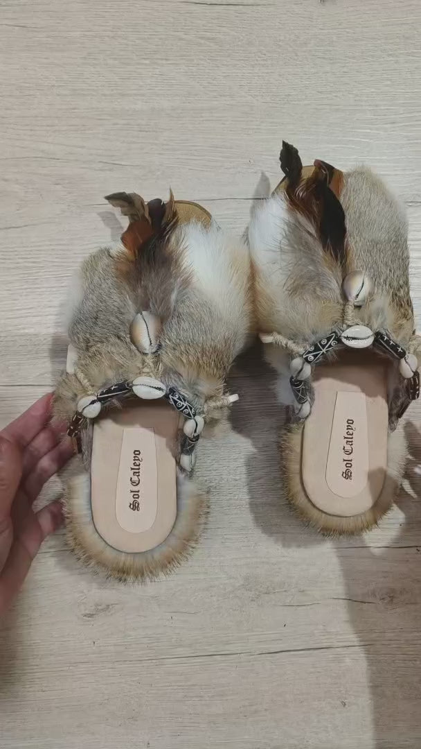 Platform clogs made of leather and rabbit fur, decorated with horns, shells and feathers for a bohemian style. Sizes 34 to 47. The Viking Clogs are an exclusive design by Sol Caleyo.