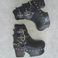 Black leather platform boots with silver studs. Black leather biker style boots with buckles. Black leather ankle boots with vintage style buckles. Leather boots with wooden heel. High-end handmade footwear by Sol Caleyo.