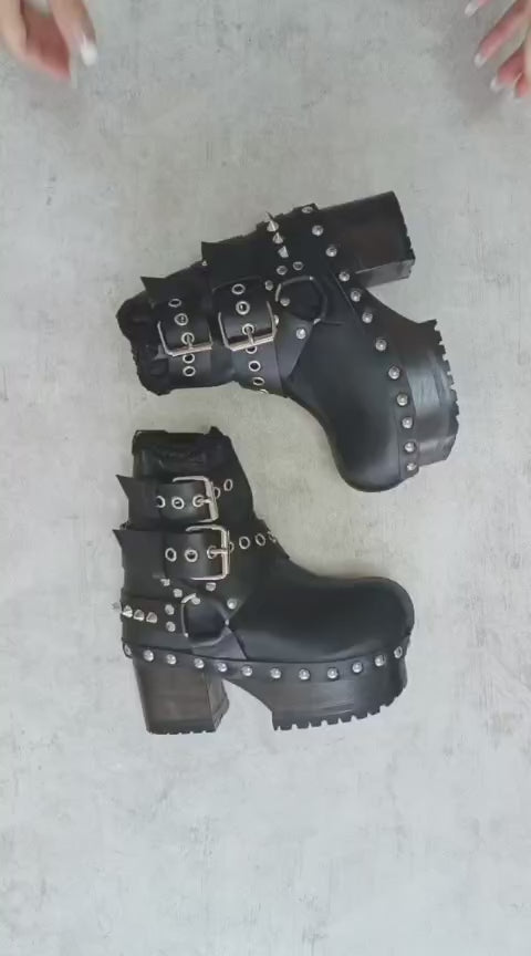 Black leather platform boots with silver studs. Black leather biker style boots with buckles. Black leather ankle boots with vintage style buckles. Leather boots with wooden heel. High-end handmade footwear by Sol Caleyo.