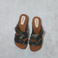 Wooden sole and black Vibram grip outsole on men’s handmade leather clog sandals.
