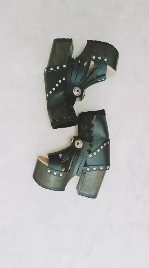Black leather platform sandal. Leather boot with super high wooden heel. Black leather boot decorated with fringes and silver conchos. Bohemian style boots. Sizes 34 to 47. High quality leather shoes handmade by sol Caleyo. Sustainable fashion.