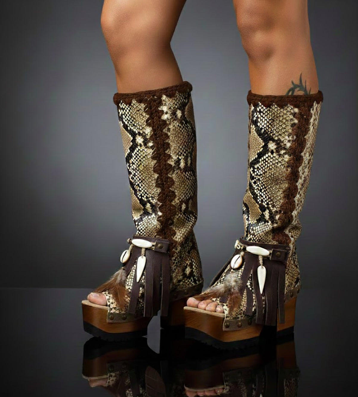 AI model wearing handmade bohemian snake leather platform boots with wooden heel and feather details by Sol Caleyo