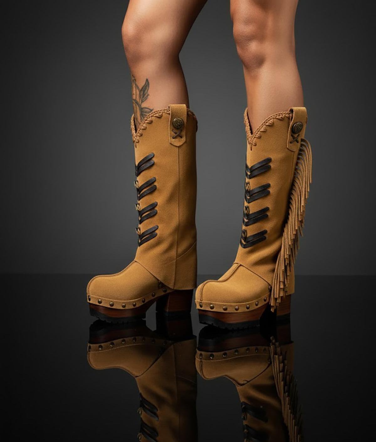 Side view of handmade western boho boots on model, suede fringe movement and sculpted wooden heel by Sol Caleyo.