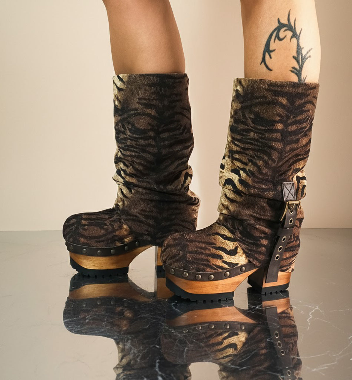 Sol Caleyo Tiger Boots - Handcrafted tiger-print suede boots with 3.5-inch wooden platform and antique gold buckle.