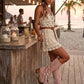 Model wearing Kozani Pink festival boots in a boho-chic summer outfit with a vintage-inspired look.