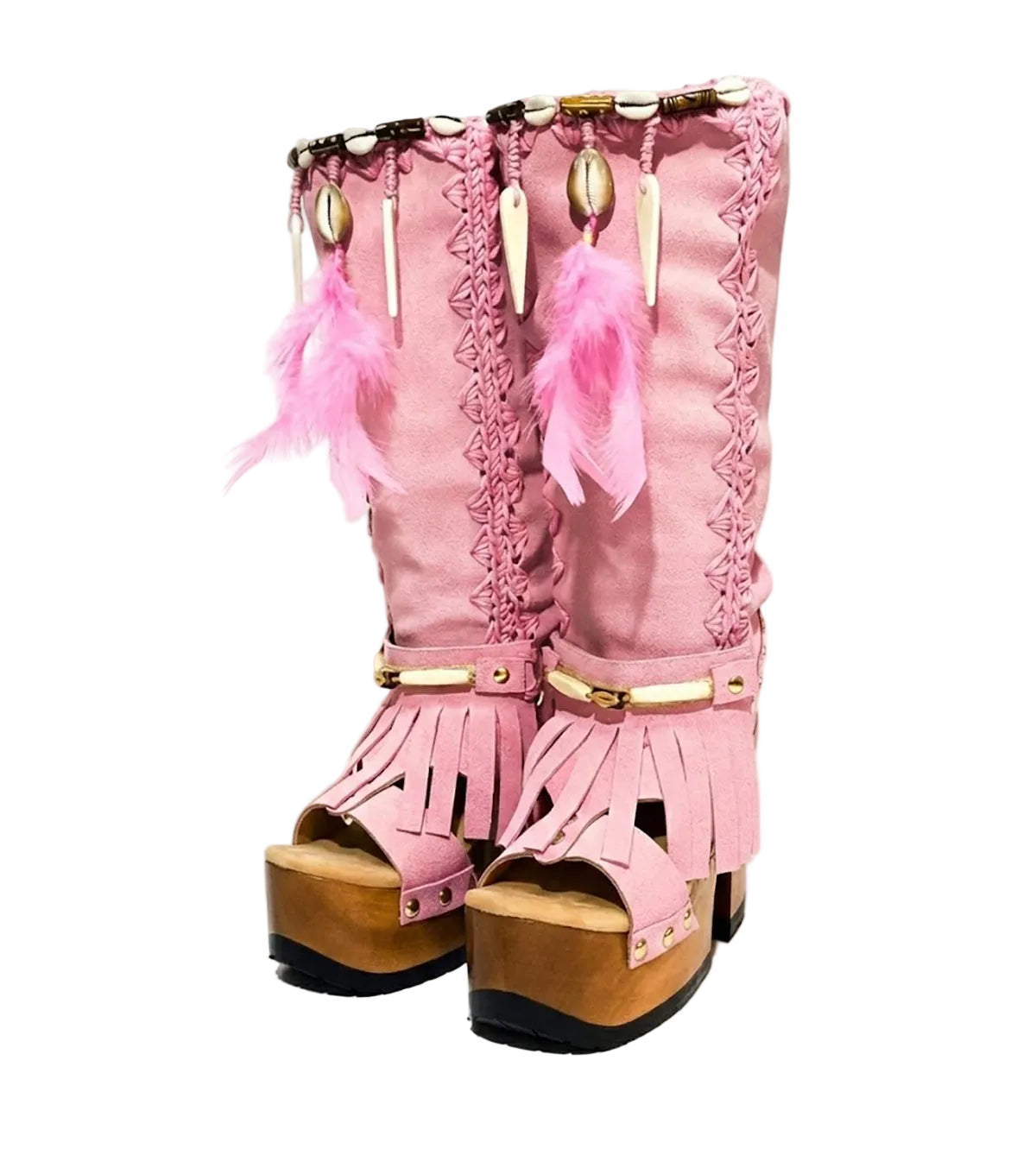 Close-up of Rhapsody Bohemia Pink Boots in premium pink suede with fringe, hand-selected feathers, and organic shells. These artisanal boho boots by Sol Caleyo feature a high hand-sculpted wooden heel and platform.