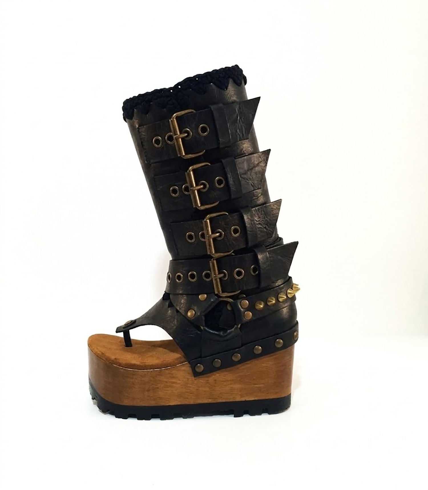 Luxury handmade Alabama Flip Flops Black Boots in black leather, showing the 10 cm wooden wedge, Vibram tractor sole, and old gold pyramid stud details.