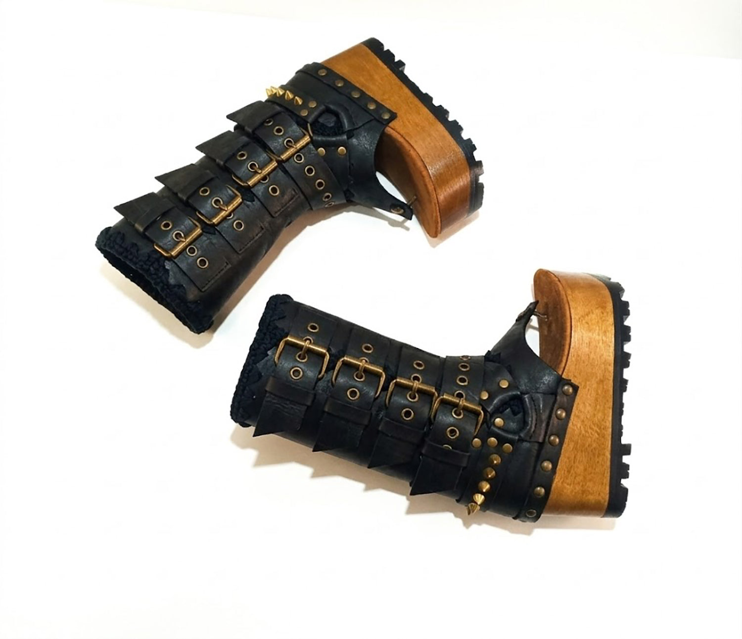 Luxury handmade Alabama Flip Flops Black Boots in black leather, showing the 10 cm wooden wedge, Vibram tractor sole, and old gold pyramid stud details.