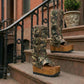 Handmade Alabama Flip Flops Army Boots in camouflage leather, featuring old gold pyramid studs, a wooden wedge, and a black Vibram tractor sole.