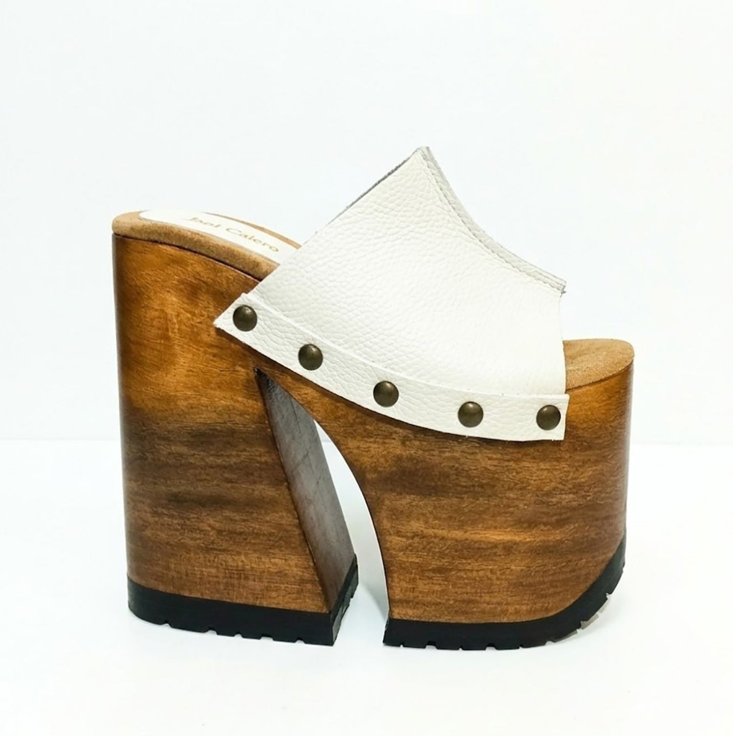 Side view of White Luxury Queen Sandals by Sol Caleyo featuring 17cm bell-style wooden heel and 11cm hand-carved platform. High-end handcrafted white leather platform sandals with vintage studs and padded goatskin suede insole. Artisanal luxury footwear for women, 100% handmade.