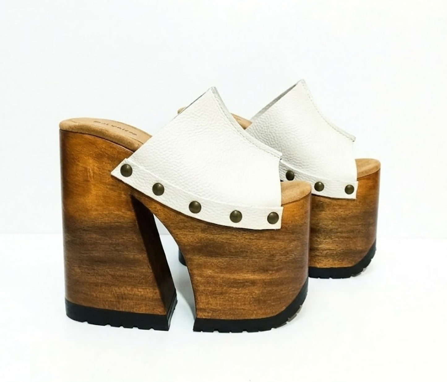 Side view of White Luxury Queen Sandals by Sol Caleyo featuring 17cm bell-style wooden heel and 11cm hand-carved platform. High-end handcrafted white leather platform sandals with vintage studs and padded goatskin suede insole. Artisanal luxury footwear for women, 100% handmade.