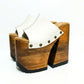 Side view of White Luxury Queen Sandals by Sol Caleyo featuring 17cm bell-style wooden heel and 11cm hand-carved platform. High-end handcrafted white leather platform sandals with vintage studs and padded goatskin suede insole. Artisanal luxury footwear for women, 100% handmade.