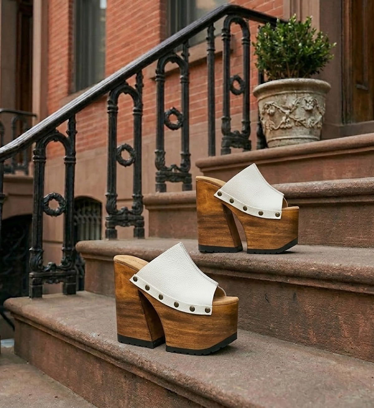 Side view of White Luxury Queen Sandals by Sol Caleyo featuring 17cm bell-style wooden heel and 11cm hand-carved platform. High-end handcrafted white leather platform sandals with vintage studs and padded goatskin suede insole. Artisanal luxury footwear for women, 100% handmade.