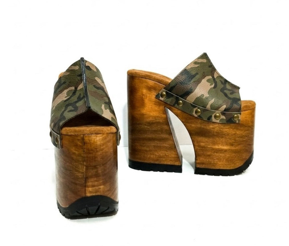 Handcrafted Armi Luxury Queen Sandals by Sol Caleyo featuring camouflage print leather, 17cm bell heel, and 11cm hand-carved wooden platform on a white background.