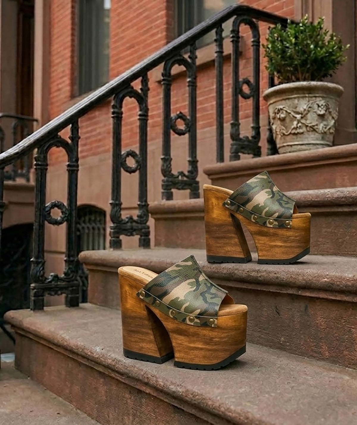 Handcrafted Armi Luxury Queen Sandals by Sol Caleyo featuring camouflage print leather, 17cm bell heel, and 11cm hand-carved wooden platform on a white background.