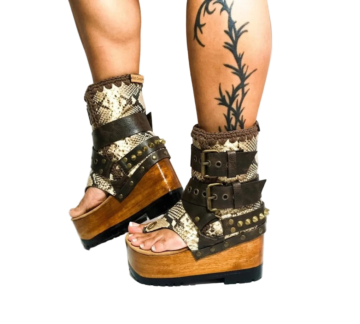 Model wearing Kenya Flip Flop Snake Boots by Sol Caleyo, featuring exotic snake leather and old gold studs in a high-fashion streetwear look.