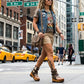 Model wearing Kenya Flip Flop Snake Boots by Sol Caleyo, featuring exotic snake leather and old gold studs in a high-fashion streetwear look.