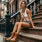 Model wearing the Kenya Flip Flop Camel Boots by Sol Caleyo, showcasing the warm camel leather and chunky wood platform in a summer boho look.