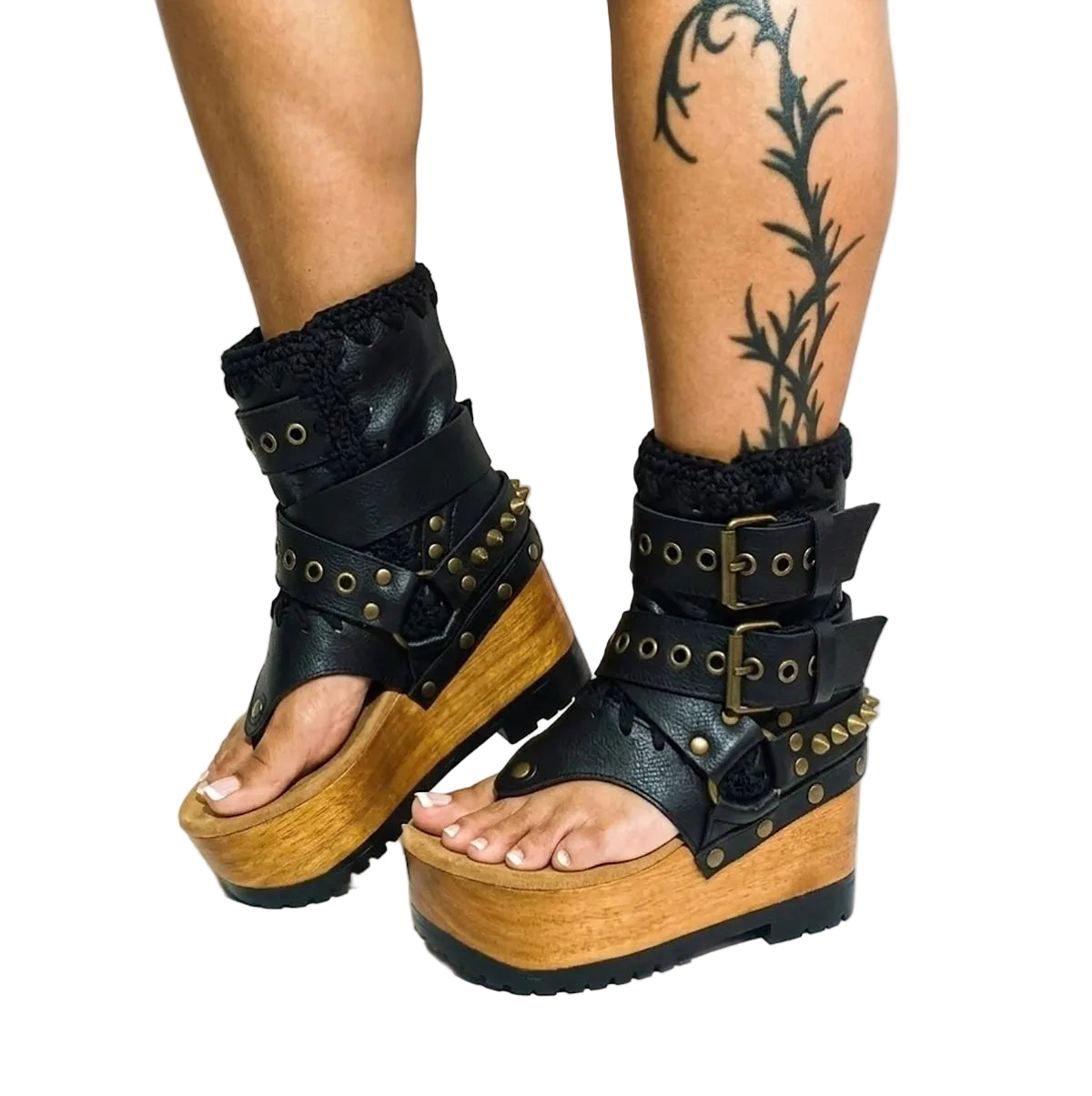 Fashion model styling the Kenya Flip Flop Black Boots by Sol Caleyo, featuring black leather and high wooden platforms in a rock-inspired boho look.