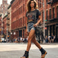 Fashion model styling the Kenya Flip Flop Black Boots by Sol Caleyo, featuring black leather and high wooden platforms in a rock-inspired boho look.