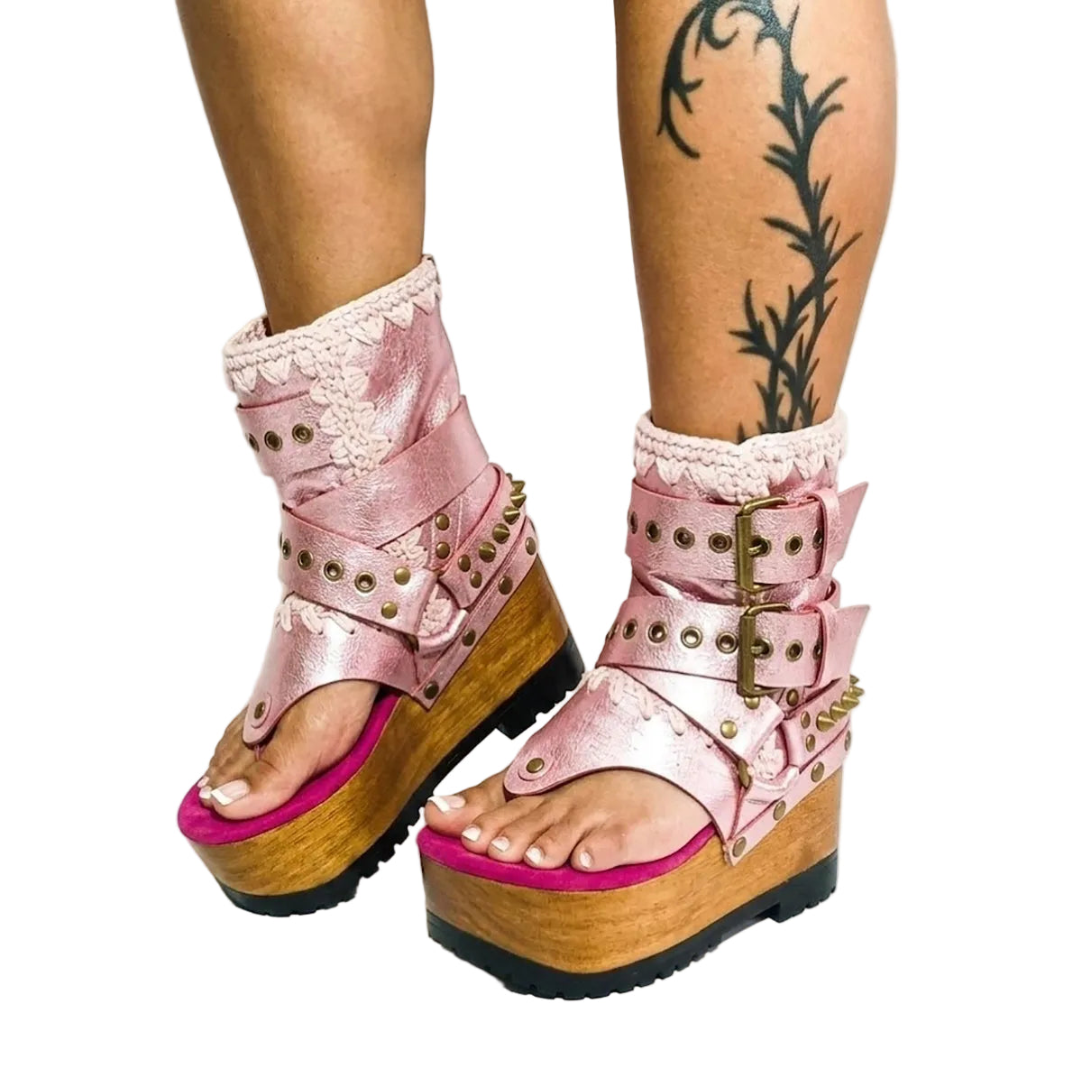 Model wearing the Kenya Flip Flop Pink Boots by Sol Caleyo, featuring metallic pink leather and high wooden platforms in a bright, edgy summer outfit.