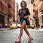 Model wearing the Kenya Flip Flop Pink Boots by Sol Caleyo, featuring metallic pink leather and high wooden platforms in a bright, edgy summer outfit.