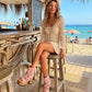Model wearing Pink Aruba Boots by Sol Caleyo, featuring pink suede and high wooden platforms in a boho-chic aesthetic.