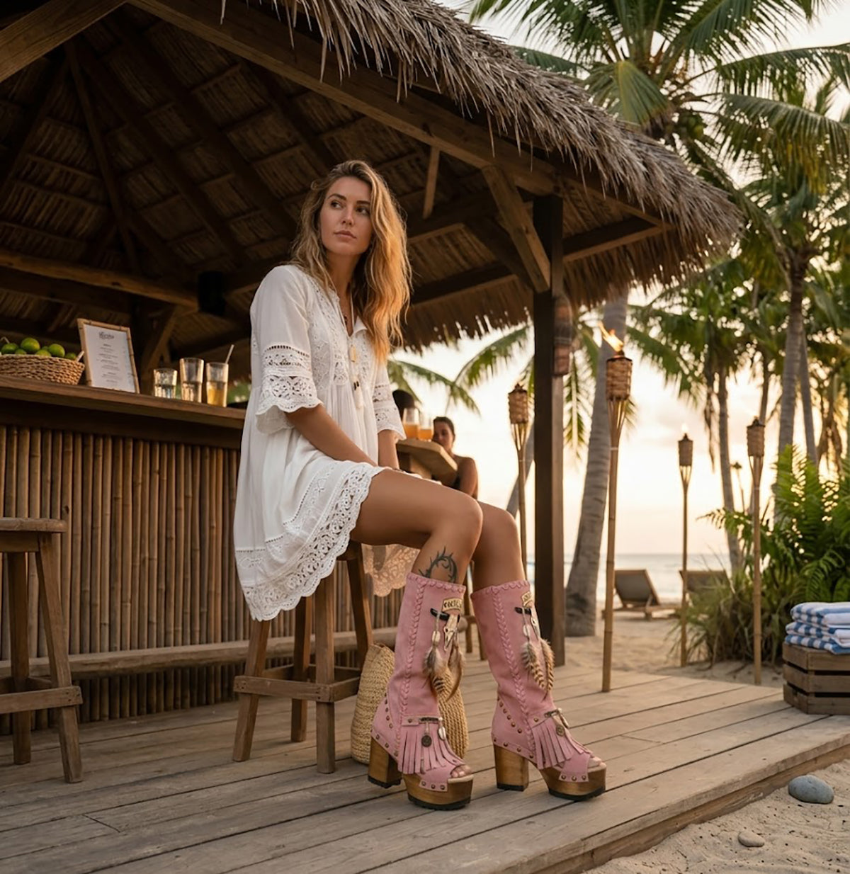 Model wearing Wild Soul Pink Boots by Sol Caleyo, handmade pink leather boho boots with high wooden platform heel in a lifestyle setting.