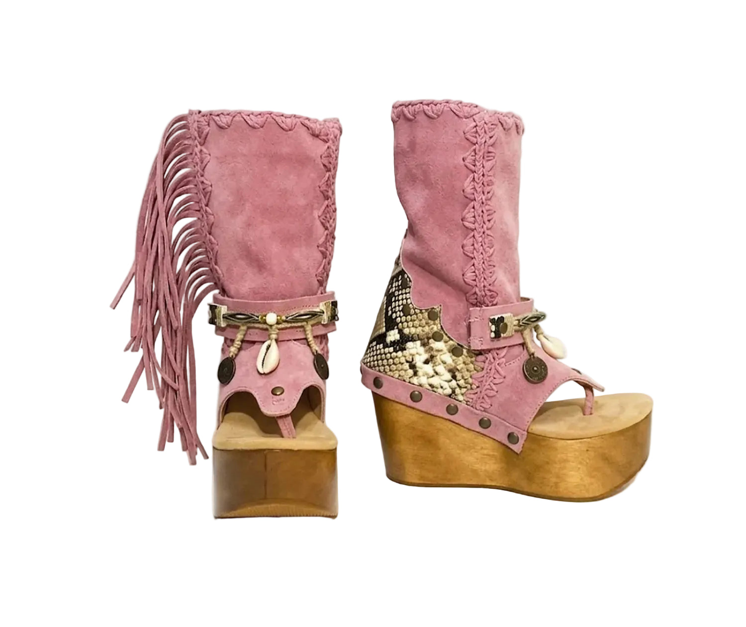 Handmade Atenea Pink Flip Flop Boots by Sol Caleyo, featuring pink suede leather, fringe details, shells, vintage coins, and a high wooden platform sole on a white background